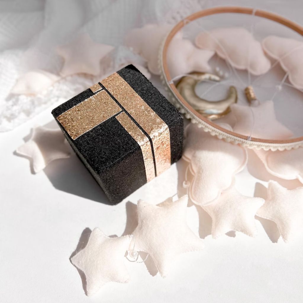 Close-up of Kaaba centerpiece with gold details and soft plush stars from Quran Speaker Baby Mobile – Islamic nursery mobile decor