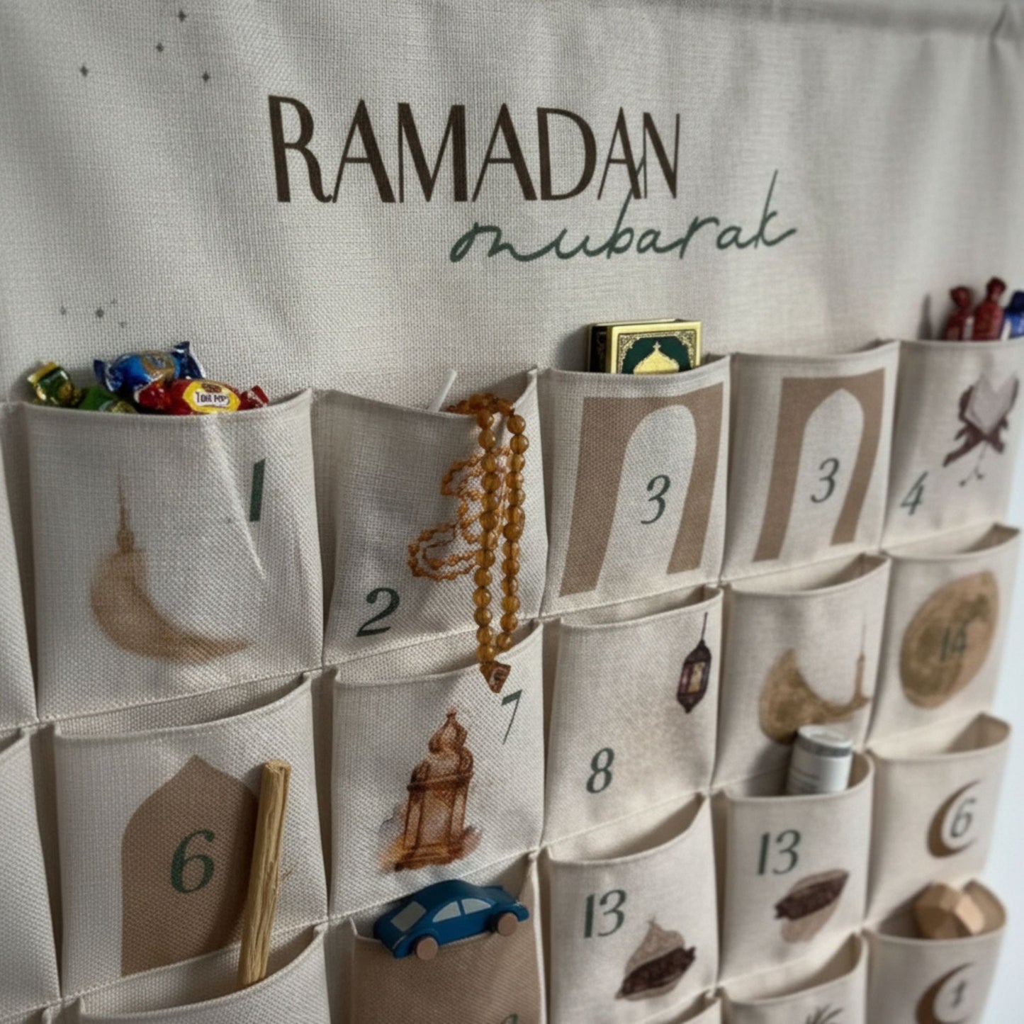 Ramadan countdown calendar with numbered fabric pockets filled with treats, tasbih and small Quran gifts