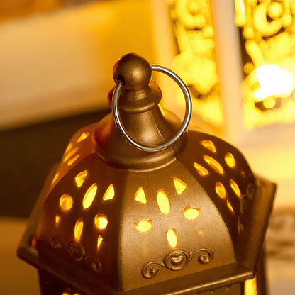 Close-up of a golden Ramadan Fanouz lantern glowing warmly, showing intricate cutout design and metal ring handle by Islamify
