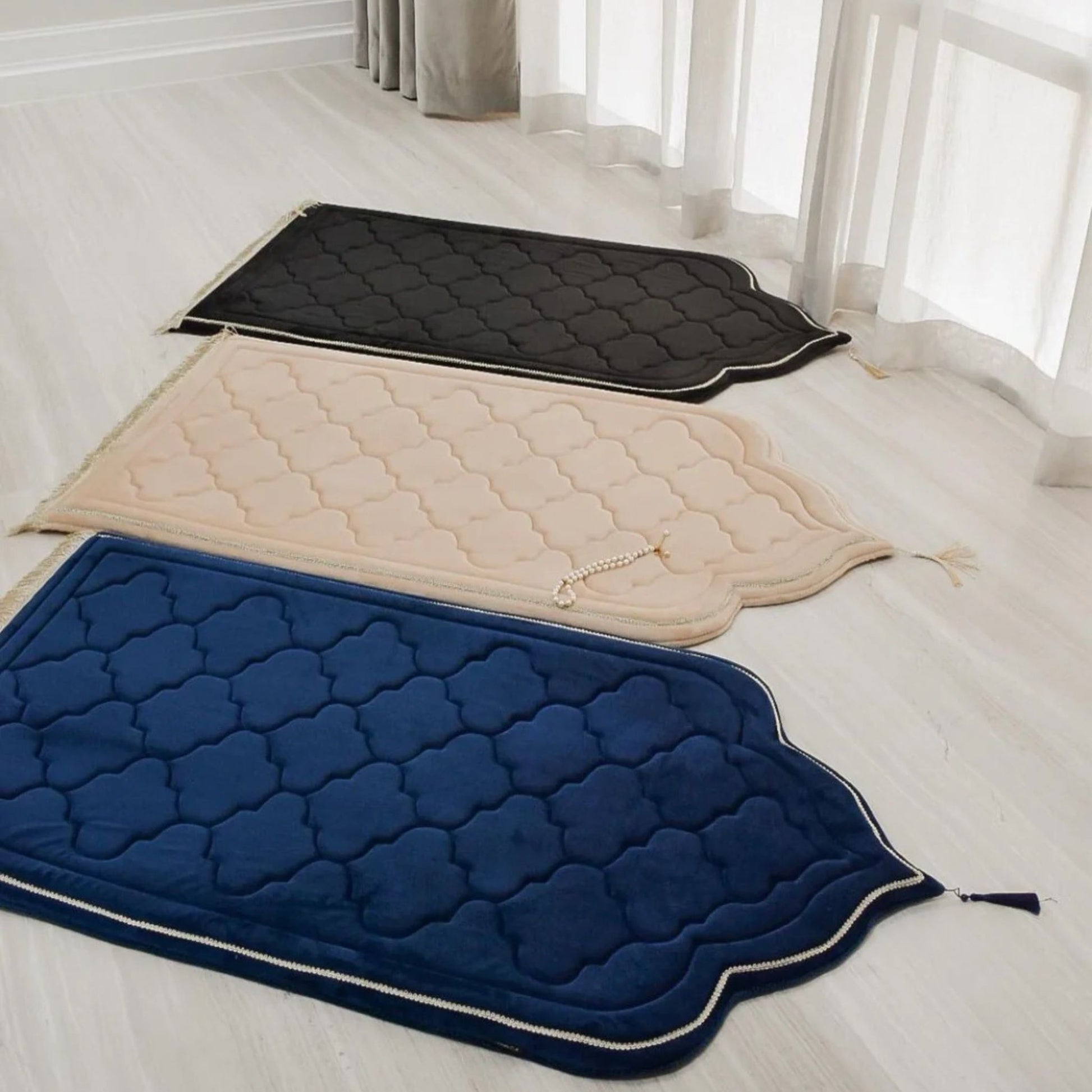 Luxury foam padded prayer mats in black, beige, and navy blue by Islamify