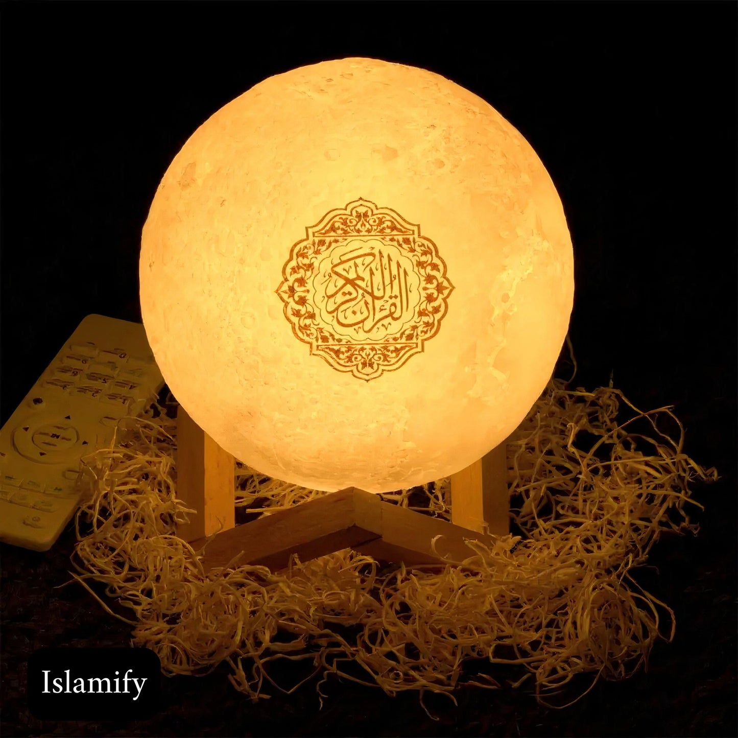 A Moon Lamp with an integrated Quran speaker, illuminated and displaying Arabic script and remote control.