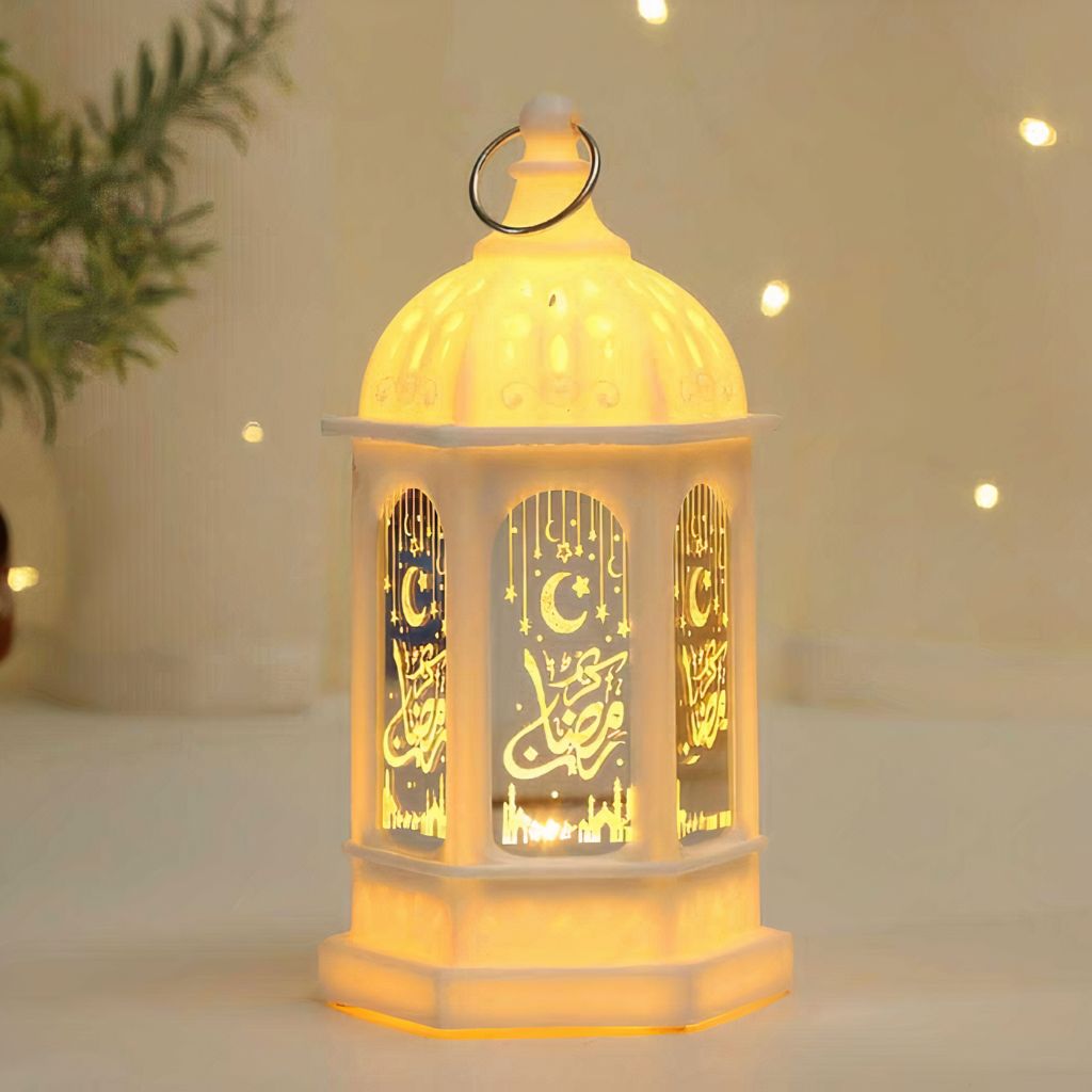 White Ramadan Fanouz lantern with golden Arabic calligraphy and warm glowing light by Islamify