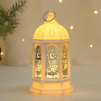 White Ramadan Fanouz lantern with golden Arabic calligraphy and warm glowing light by Islamify